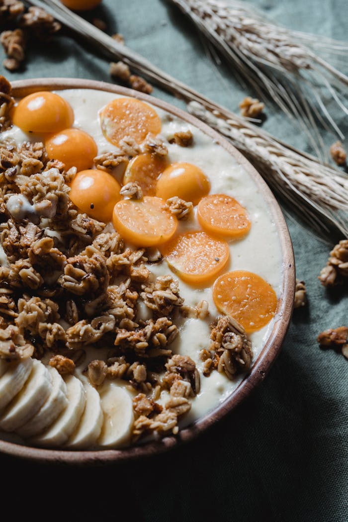 Close-up of a nutritious breakfast bowl with fresh fruits, granola, and creamy yogurt.